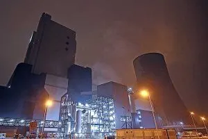 Power station with cooling towers lit at night