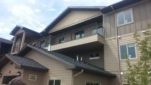 Multi-story building exterior with balcony railing and a fire alarm control panel labeled FACP Inside