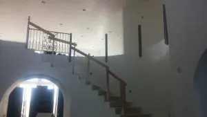 Wrought iron stair railing with scrollwork in an unfinished home interior