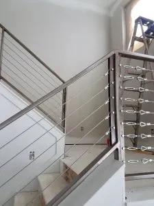 Stainless steel cable railing on an interior staircase under construction