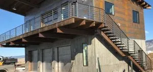 Steel deck railing and open-riser staircase on a modern steel-clad building