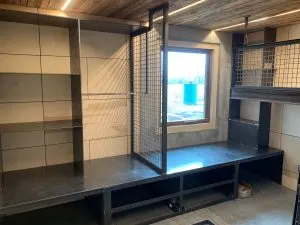 Custom steel shelving, workbench, and mesh partition in an industrial interior