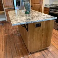 Kitchen island with granite top on a wood cabinet base